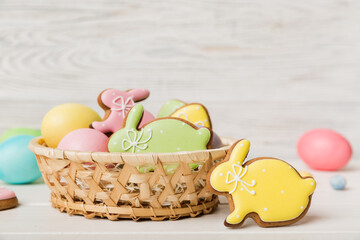 Colorful easter cookies in basket with Multi colors Easter eggs on colored background . Pastel color Easter eggs. holiday concept with copy space