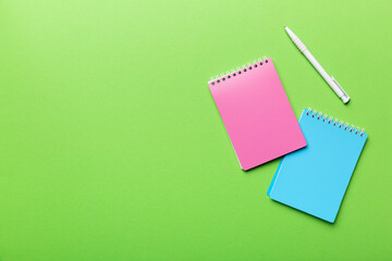 two school colored notebook on a desk background, spiral craft notepad on a table Top view