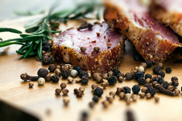 dried and spiced meat sliced on a wooden board