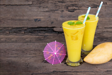 Mango  juice fruit smoothies yogurt drink yellow healthy delicious taste in a glass slush for weight loss on wooden background.
