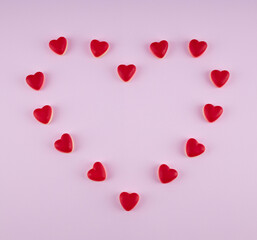gummy red hearts on a pink background