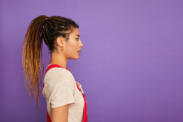 Profile of woman with braided hair against purple background