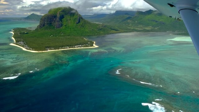 View of mauritius ocean coast, underwater watefall and Le Morne mountain from float plane cabin