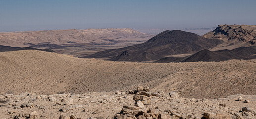 View of Ramon Crater from West to East as seen from Mount Ramon, a 500 m deep, the world's largest erosion cirque, located in the Negev Desert, south of Beer Sheba, Israel. - obrazy, fototapety, plakaty