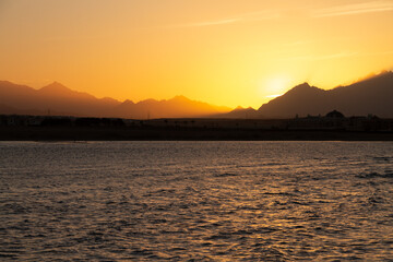 Obraz premium natural background sunset view of the sea, mountains