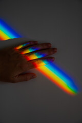 Rainbow ray on a woman's hand. 
