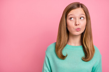 Photo of doubtful school girl dressed teal pullover looking empty space isolated pink color background - obrazy, fototapety, plakaty