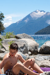 Child in nature with a mountain in the background.	
Boy on the beach. A young person playing in the sand
