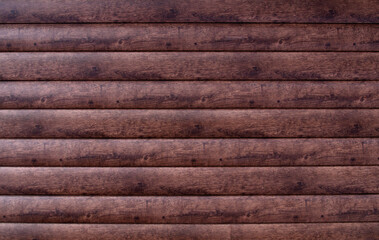 External plastic wall panel . Imitation of dark wood texture. Dark brown background close-up.