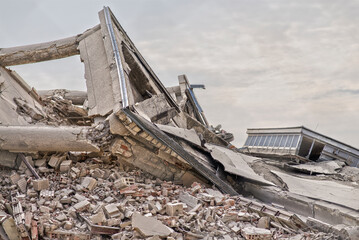 Collapsed industrial building. Scene full of debris and dust. 