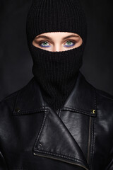 beautiful girl in black balaclava and leather coat. Trendy Mask