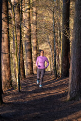 Young woman jogging in forest