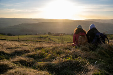 Rear view of female hikers looking at sunset