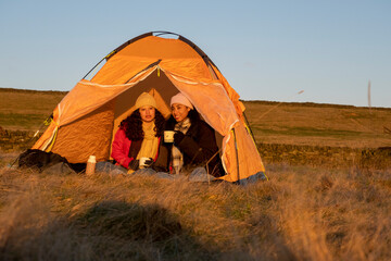 Friends camping in rural landscape
