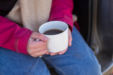 Woman holding mug with hot drink