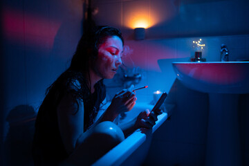 Lonely woman drunk sit in bath smoking jealous follow ex boyfriend or husband in social media....