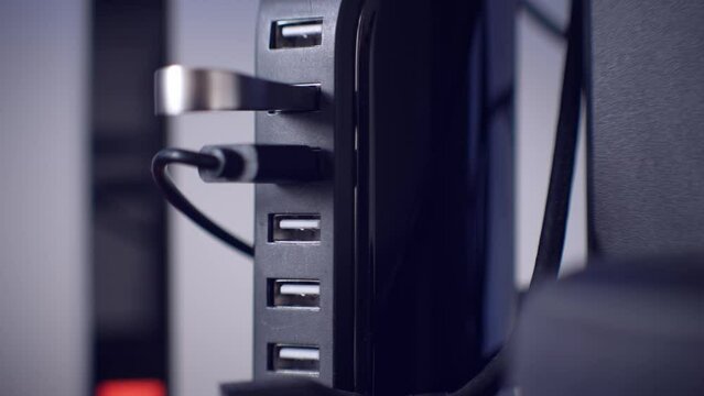 Modern convenient multi-port usb charger for devices. Close-up of inserted USB stick into a USB hub. Macro.