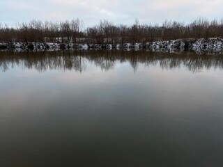 Fototapeta premium Dark water of the river in winter.