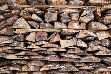 stack of firewood made from old planks close up view