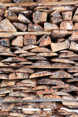stack of firewood made from old planks close up view