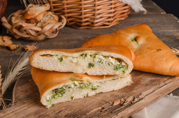 Appetizing fresh culinary pastry - pies with different fillings on a wooden