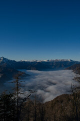 View on Kamnik-Savinja Alps over the foggy valley from Krvavec Ski Resort, Gorenjska Region, Slovenia