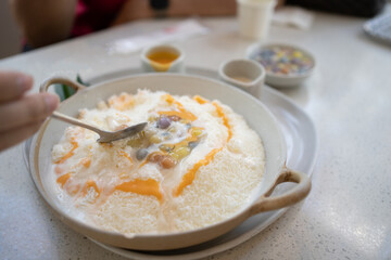 Salty Egg Yolk Bua-Loi Bingsu. Dessert on a table at cafe. korean shaved ice dessert 