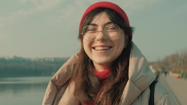 4K Resolution (3840&times;2160) of portret of happy young girl in glasses who laughs near the lake.