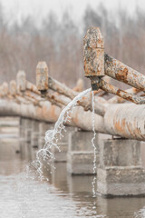 Old steel rusty abandoned pipes of the water cooling pipeline system of the combined heat and power...