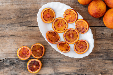 Top view of Sanguinelli  bllod oranges , sliced on a white plate.