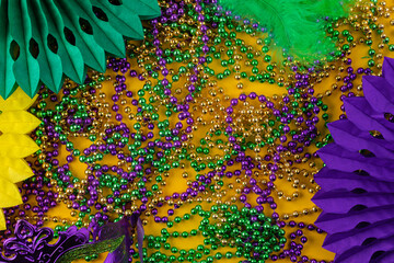 Mardi gras carnivale green, purple, yellow beads and colorful decorations