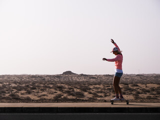 Caucasian skater woman riding surfskate by the nature in Fuerteventura © 1 MEDIA
