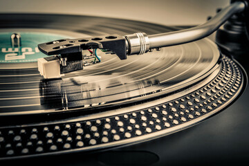 A needle on a turntable that plays music