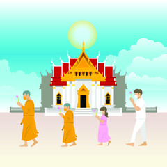 Monks and people are walk with lighted candles around a temple on religious days for Makha, Visakha, Asarnha Bucha, Visak and buddhist lent day in Covid-19 new normal Social distancing with face mask