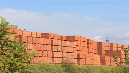 Fototapeta premium Tavelloni di colore rosso, laterizi accatastati all 'aria aperta. Materiali per edilizia.