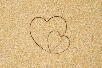 Hand-drawn shape of two heart on sand tropical beach. valentines day. Holiday concept. Creative, background, copy space, travel, summer. Flat lay