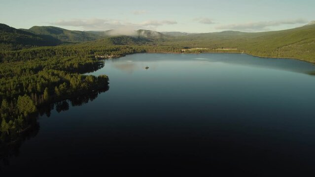 Aerial view of Lake Sandvatn 4K Fly Over Reflection Trees Norway Mountain 30pfs