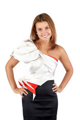 Smiling beautiful young woman in black white red dress, standing and looking at camera. Studio shot, cropped mid-thigh, isolated on white