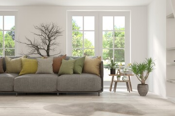 White living room with sofa and summer landscape in window. Scandinavian interior design. 3D illustration