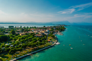 Fototapeta na wymiar Aerial view of Sirmione resort coastline in Italy on the shore of Garda lake in Lombardy
