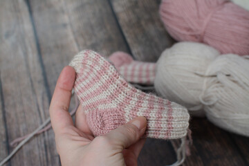 Fototapeta na wymiar Colorful striped baby socks, made of organic wool yarn