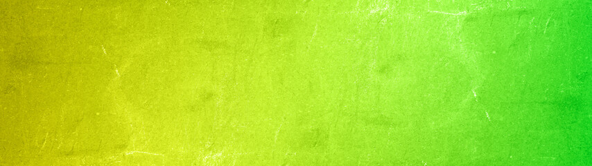 Abstract yellow neon green colored stone concrete cement scratched weathered grunge wall or floor texture background panorama banner long