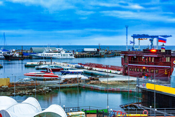 Seaport of small vessels in winter in cloudy weather in the evening