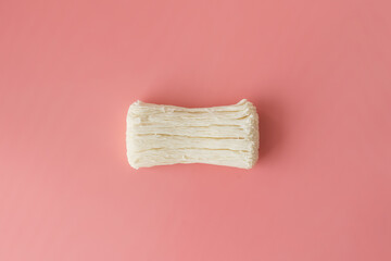 Dried cracked soap on a pink background. Empty space for the text.