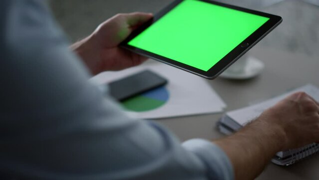 Man hands using tablet device green screen research business finance in office.