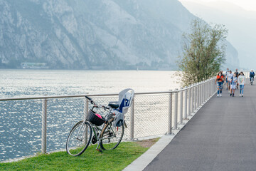 Milan, Italy - September 15, 2021: bicycle road and foot path over Como lake with beautiful...