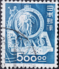 Japan - circa 1949: a postage stamp from Japan , showing workers welding while making a boiler for...