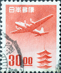 Japan - circa 1951: a postage stamp from Japan, showing a Douglas DC-4 over the Horyu-ji Pagoda,...