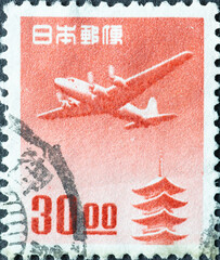 Japan - circa 1951: a postage stamp from Japan, showing a Douglas DC-4 over the Horyu-ji Pagoda, Nara 30.00  red