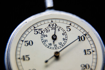 An old clock on a dark background.